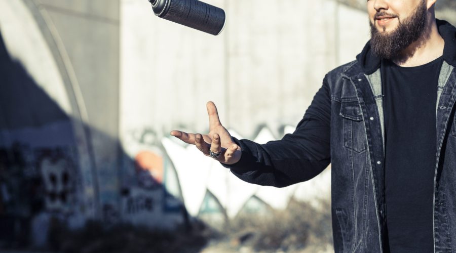 man-throwing-aerosol-can-mid-air