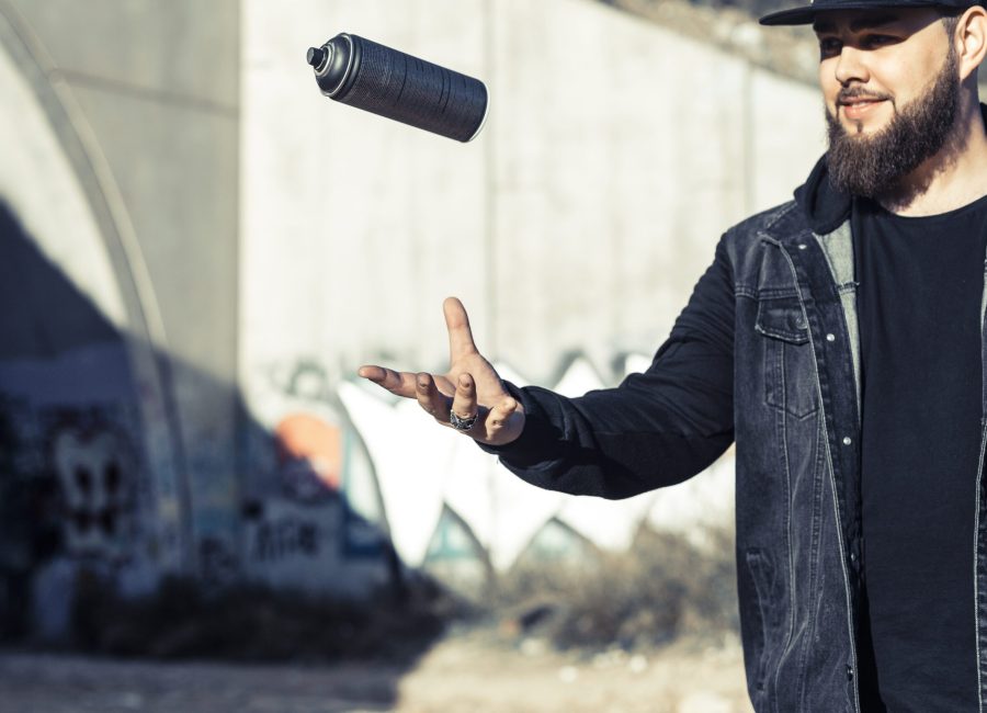 man-throwing-aerosol-can-mid-air
