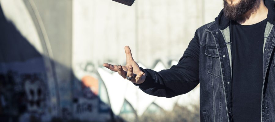 man-throwing-aerosol-can-mid-air