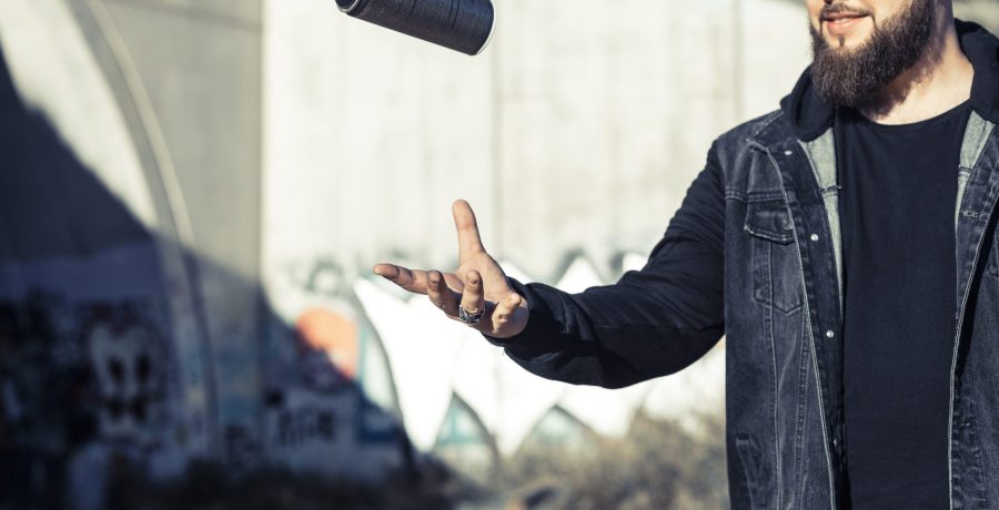 man-throwing-aerosol-can-mid-air