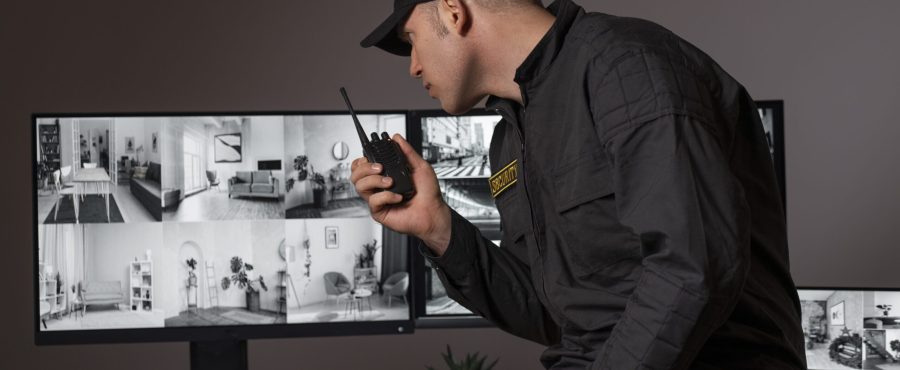 portrait-male-security-guard-with-radio-station-camera-screens